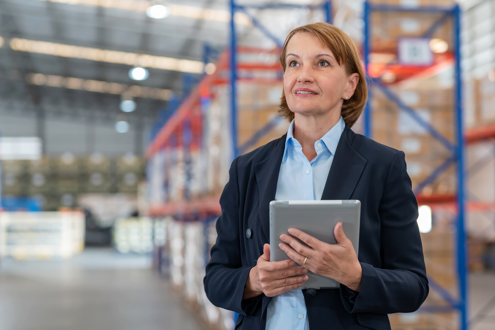 expert employee standing with a laptop